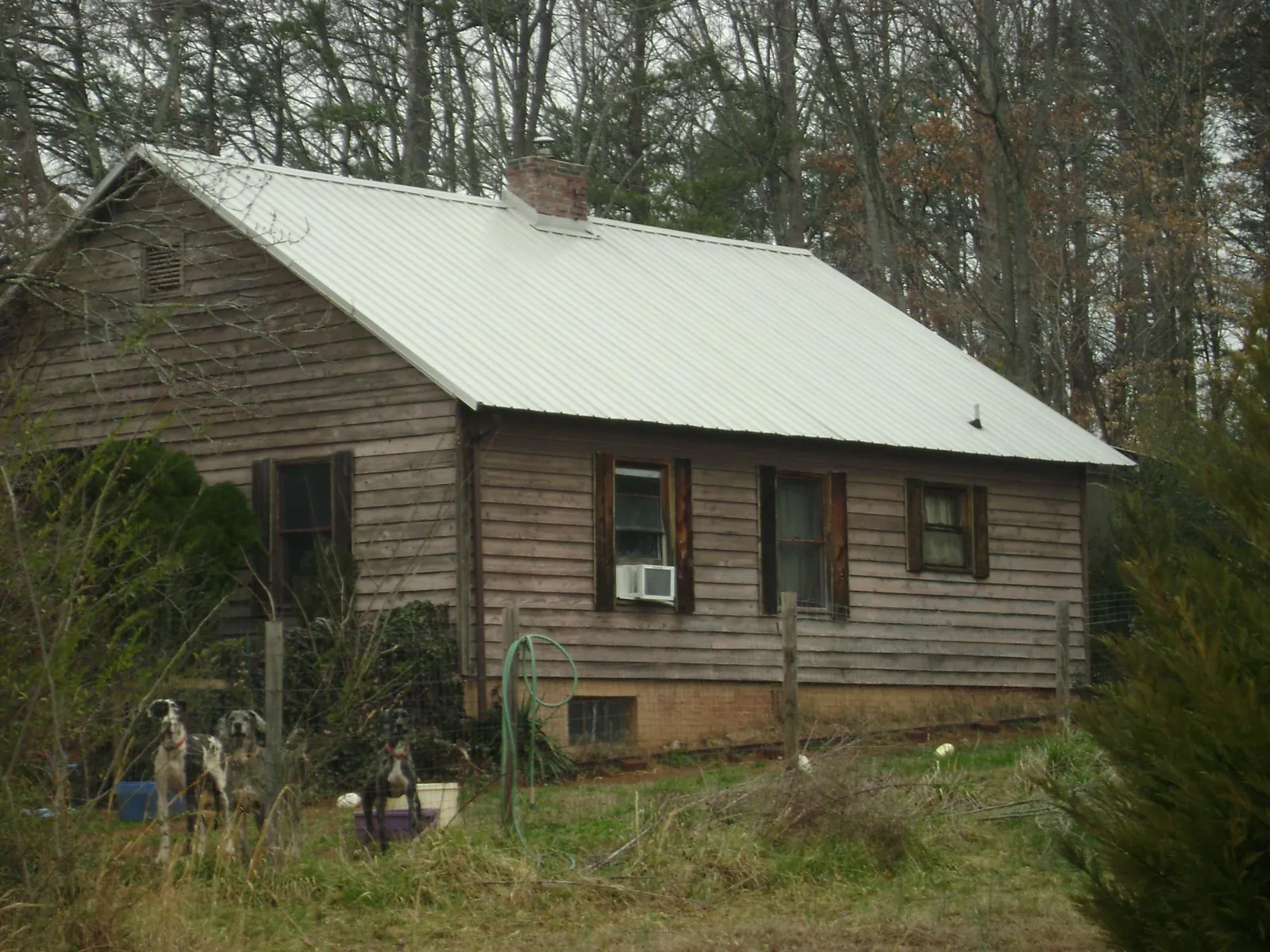 White metal roof on an old wood sided farmhouse, from a Metal Roof Installation job in Albertville